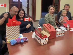 Refugee families from Crimea and Odessa are welcomed to Sudbury during a recent visit to the office of MP Viviane Lapointe. Supplied