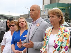 Sudbury NDP candidate Jamie West makes a point as Nickel Belt NDP candidate France Gelinas, right, and supporters look on at a press conference near Health Sciences North in Sudbury, Ont. on Monday May 30, 2022. John Lappa/Sudbury Star/Postmedia Network