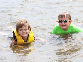 Seth Gannon-Derrah, 6, left, and his brother, Phyneas, 8, cool off in Ramsey Lake in Sudbury, Ont. on Monday May 30, 2022. John Lappa/Sudbury Star/Postmedia Network