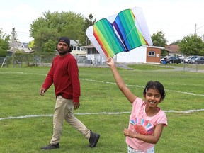 Vivek Sanan looks on as his daughter, Mahi, 9, attempts to fly a kite at Robinson Playground in Sudbury, Ont. on Tuesday May 31, 2022. John Lappa/Sudbury Star/Postmedia Network