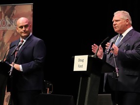 Ontario PC party leader Doug Ford makes a point at the Federation of Northern Ontario Municipalities debate at the Capitol Centre in North Bay, Ont. as Liberal leader Steven Del Duca listens in on Tuesday, May 10, 2022.