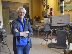 ]The Kiwanis Club of Forest's Ruth Illman stands on the second floor of the Kineto Theater in this file photo, among artifacts from the building's 100-plus-year history.  File photo/Postmedia