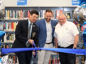 Lambton County Warden Kevin Marriott (left), Lambton County's General Manager of Cultural Services Andrew Meyer (center) and Lambton Shores Mayor Bill Weber (right) cut the ribbon at the re-opening of the newly refurbished Forest Library on May 3. Carl Hnatyshyn /Sarnia This Week