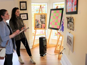 Lambton County Student Art Show jurors Sarah Ford (left) and Madelyn Epps (right) gaze at student-made artwork on display at Lawrence House Centre for the Arts. 
Carl Hnatyshyn/Sarnia This Week