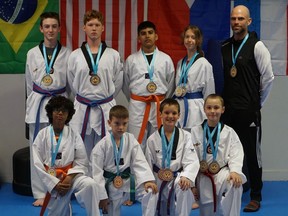Members of Sarnia Olympic Taekwondo Academy won 16 medals during a May 14 tournament at Eastern Michigan University. In the front row, from left: Aaj Akash, Cole Burling, Ben Thomas and Jax Albert. In the back row, from left: Wyatt Langford, Austin St. Jean, Arveer Akash, Anika Botma, club coach Master Mark Warburton. Submitted