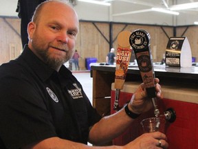 Benjie Potvin, co-owner of Full Beard Brewing, was among the nine vendors pouring suds at the McIntyre Curling Club on Saturday for Beerfest.

RON GRECH/The Daily Press