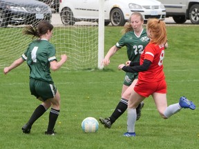 Glendale defenders Reegen Lindie (left) and Katie Parkins rush to clear the ball in Friday’s Gemini Cup soccer game against WCI. CHRIS ABBOTT