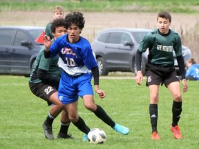 Simcoe Composite School's Dildar Dirbas (10) looks for an open teammate in the midfield Friday during the Gemini Cup second-place championship game against host Glendale HS. CHRIS ABBOTT/Norfolk and Tillsonburg News