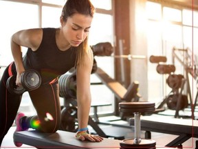 A woman works out with weights