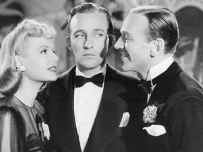 The song "White Christmas", sung by Bing Crosby and Marjorie Reynolds, first appeared in the 1942 film "Holiday Inn".  The song was written by Irving Berlin and would become the best-selling single of all time.  Shown from left: Marjorie Reynolds, Bing Crosby, Fred Astaire.
