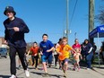 The participants of the one-kilometre Kids Fun Run begin their run, following their guide, on May 8. Angela Cammaert