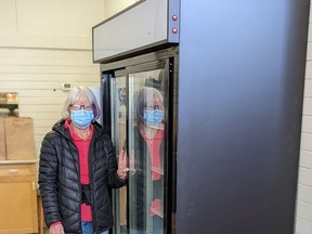 Donna Mylrea, a volunteer with West Elgin Daffodil Auxiliary-Welfare, is shown next to a large cooler the auxiliary purchased for its food bank in Dutton. (Handout/Postmedia Network)