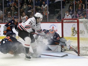 Colby Barlow scores a shorthanded goal in the second period with a backhand shot just missing the outstretched stick of goaltender Luke Cavallin as the Flint Firebirds host the Owen Sound Attack in Game 5 of their Western Conference best-of-seven quarterfinal series on Sunday, May 1, 2022. Greg Cowan/The Sun Times