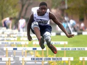 St. Mary's Yuhai Mukenge clears a hurdle en route to winning the junior boys 100-metre hurdles prelim. Greg Cowan/The Sun Times