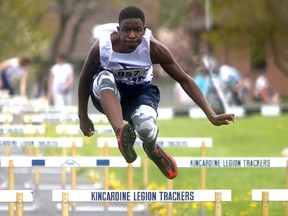 St. Mary's Yuhai Mukenge clears a hurdle en route to winning the junior boys 100-metre hurdles prelim. Greg Cowan/The Sun Times