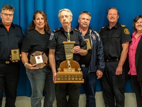 Grant Robinson (front) was presented with the Havery Gunnis memorial trophy in recognition of years of commitment to the community as a volunteer firefighter. John Campbell (back left) from Southampton was a second runner-up. Paula Turner from Tiverton was the first runner-up. Larry Meyer was another second runner-up. South Bruce Peninsula Fire Chief Tim Wilson and Warden of Bruce County Janice Jackson honoured the nominees. Lauren Messer from Paisley, Keith Steingart from Port Elgin and Steve Culbert from Mildway were all second runners-up but were not able to attend the meeting. Matt Bacon