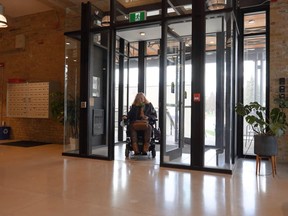 Stratford accessibility advisory committee member Diane Sims is seen here using the accessible, barrier-free entrance to the Bradshaw Building on the corner of Falstaff Street and Downie Street. This screenshot is from one of the videos released this week by the committee and Heritage Stratford as part of National Accessibility Week to highlight accessibility in a few of Stratford's heritage and historic buildings. (Submitted screenshot)