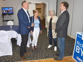 Bruce-Grey-Owen Sound Progressive Conservative candidate Rick Byers, left, and his wife Margot, second from left, chat with outgoing Bruce-Grey-Owen Sound MPP Bill Walker and his wife Michaela at the Quality Inn in Owen Sound on Thursday, June 2, 2022.