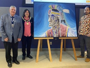 Bruce County Chief Administrative Officer Derrick Thomson, Bruce County Warden Janice Jackson, and Artist Brent Henry with a painting by Henry that was commissioned by the county.