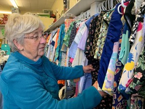 Elaine Burrows, a member of  IODE Dr. Herbert A. Bruce Chapter, shows some of the clothing bargains at the Victory Shop. The shop, located at 358 Algonquin Avenue, offers bargain prices for a variety of treasures. The local chapter help their annual “Toonie” garage sale Saturday.