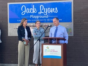 Mark Lyons is joined by his family Lesley and their daughter Hannah to speak to a crowd gathered at One Kids Place Friday morning to unveil new playground equipment in memory of 17-year-old Jack Lyons.