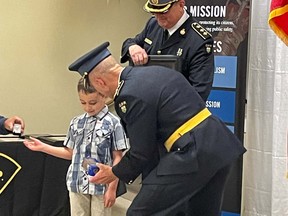Jackson True, 7, receives his award from OPP Commissioner Thomas Carrique at the Davedi Club on Thursday.