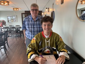 Will Bourre signing with Voodoos President Jim Bruce at Average Joes in North Bay.