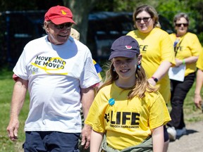 Participants in Saturday's Bay of Quinte Relay for Life walk a lap on the Loyalist College Track. The event surpassed its fundraising goal by $15,000.