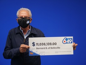 Bernard Boucher stands alongside his Lotto 6/49 winnings worth $11,036,139 after purchasing a winning ticket on April 30 at New Way Convenience on Dundas Street in Belleville. Submitted.