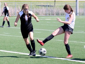 Sydney Gauthier, left, of the Lasalle Lancers battles for the ball with Trinity Chatwell of the Lively Hawks during the SDSSAA Girls Second Division soccer championship game at James Jerome Sports Complex in Sudbury, Ontario on Tuesday, June 14, 2022.