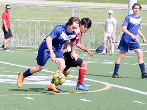 Anthony Bertrand, left, of the Bishop Alexander Carter Golden Gators and Alex Suominen of the Macdonald-Cartier Pantheres jockey for position during the SDSSAA Boys Second Division soccer championship game at James Jerome Sports Complex in Sudbury, Ontario on Tuesday, June 14, 2022.