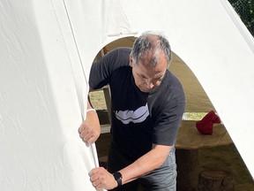 Indigenous Culture Instructor George Couchie applies finishing touches to the restored tepee at Our Lady Of Sorrows school in Sturgeon Falls. Submitted Photo