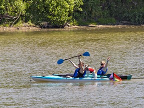 Participants in Paddle for Pride make their way down the Grand River from Onondaga, Ontario heading to Chiefswood Park on Six Nations of the Grand River Territory on Saturday.