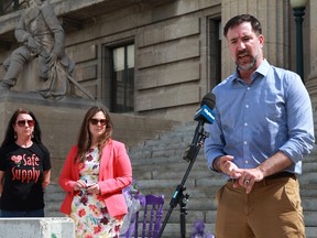 Manitoba Health Coalition executive director Thomas Linner speaks as Coun. Sherri Rollins (middle) and Manitoba regional director of Moms Stop The Harm Arlene Last-Kolb (right) look on during a news conference at the Manitoba Legislature on Monday, June 20.