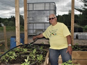 Harvey Sohm, a director and volunteer with the Magnetawan Horticultural Society, demonstrates how the improved irrigation system using large-capacity water tanks is a major improvement over watering the vegetable plots with watering cans last year.
Rocco Frangione Photo