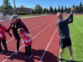 Mark Lyons shoots off the starter's pistol in a Special Olympics event that now bears his son's name.
Greg Estabrooks/The Nugget