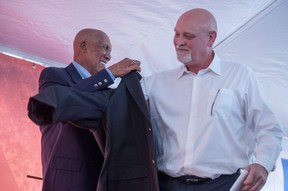 Canadian baseball legend Fergie Jenkins helps form Blue Jays reliever Duane Ward into a ceremonial jacket at the Canadian Baseball Hall of Fame and Museum in St. Marys.  Ward was inducted into the hall of fame June 18, 2022. Chris Montanini/Stratford Beacon Herald