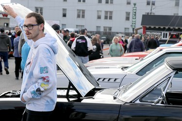 Queen Street Cruise at GFL Memorial Gardens in Sault Ste. Marie, Ont., on Friday, June 17, 2022. Josh Chartrand with father Craig Chartrand's 1966 Ford Mustang convertible. (BRIAN KELLY/THE SAULT STAR/POSTMEDIA NETWORK)