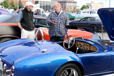 Queen Street Cruise at GFL Memorial Gardens in Sault Ste. Marie, Ont., on Friday, June 17, 2022. Robert McCarthy speaks with Tracy Brennan about his replica 1966 A.C. Cobra.(BRIAN KELLY/THE SAULT STAR/POSTMEDIA NETWORK)