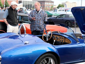 Queen Street Cruise at GFL Memorial Gardens in Sault Ste. Marie, Ont., on Friday, June 17, 2022. Robert McCarthy speaks with Tracy Brennan about his replica 1966 A.C. Cobra.(BRIAN KELLY/THE SAULT STAR/POSTMEDIA NETWORK)