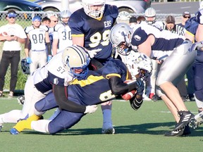 Brandon Soucy (57) and Andrew Gillis (42) of the Sudbury Spartans tackle Alonzo Clarke (8) of the Sault Steelers during Northern Football Conference action at James Jerome Sports Complex in Sudbury, Ontario on Saturday, June 18, 2022.