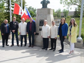 Airdrie councillors Al Jones (from left to right), Ron Chapman, Mayor Peter Brown, Minister of Culture Ron Orr, Philippine Ambassador Radolfo Robles, Consul General of Calgary Zaldy Patron, Airdrie MLA Angela Pitt and councillor Tina Petrow stand infront of the Jose Rizal monument in Nose Creek Park on June 19, shortly before unveiling the historical marker. Photo by Riley Cassidy/The Airdrie Echo/Postmedia Network Inc.