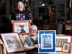 Sharon McCormick sits on a couch as she and Paul Kite, co-owner of the QuinnÕs of Tweed Gallery with is partner Paula Fitzpatrick, hold framed artwork created by Sharon's late brother John Joseph McCormick. Wednesday in Tweed, Ontario. ALEX FILIPE