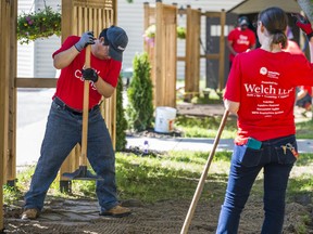 Volunteers work to level off uneven ground outside of Continuing On In Education (COED) in Belleville as part of the region-wide United Way Hastings and Prince Edward Day of Caring on Thursday. ALEX FILIPE