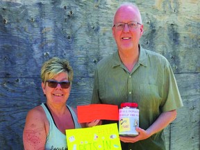 Janice Kochan presents Stuart Dodds with a notice of a $223 donation to the Pets In Need Alberta Shelter, raised at the Clairmont Business Expo. (supplied)