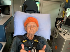 Richard Embree gives the thumbs up from the back of an ambulance after being lost in the woods for almost 24 hours. PHOTO BY RCMP