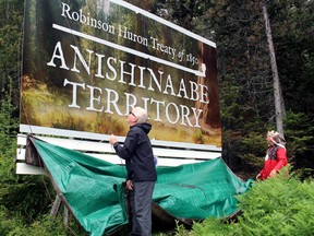 Earl Commanda, left, executive director of the Robinson Huron Waawiindamaagewin, and Chief Gerry Duquette Jr., chief of Dokis First Nation, unveil a billboard north of Marten Riveracknowledging and asserting Anishinaabe territory in the Robinson Huron Treaty area.
PJ Wilson/The Nugget