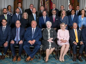 Nipissing MPP Vic Fedeli, third from right in front row, sits with Premier Doug Ford's new cabinet, sworn in Friday.