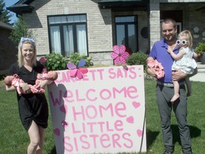 Marc and Stephanie Denomme of Exeter recently doubled the size of their family when Stephanie gave birth to triplets on June 15, making 18-month-old Scarlett a big sister to three. From left are Stephanie holding Avah and Summer, and Marc holding Ruby and Scarlett. In front is Tulo.