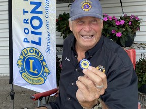 Port Dover Lions Club member John McHutchion was selling traditional Canada Day buttons outside the No Frills store in Port Dover on Sunday, June 26. The Lions Club sells the buttons to help offset the costs involved with putting on the Canada Day celebration in the lakeside town. SIMCOE REFORMER
